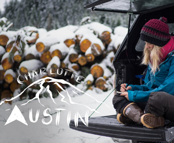 Adventure Writer Charlotte Austin writing in a notebook in the moutain snow.