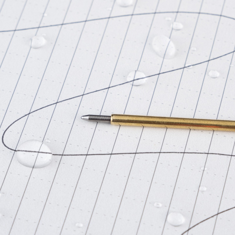 pressurized ink cartridge on wet paper with ink written through water.