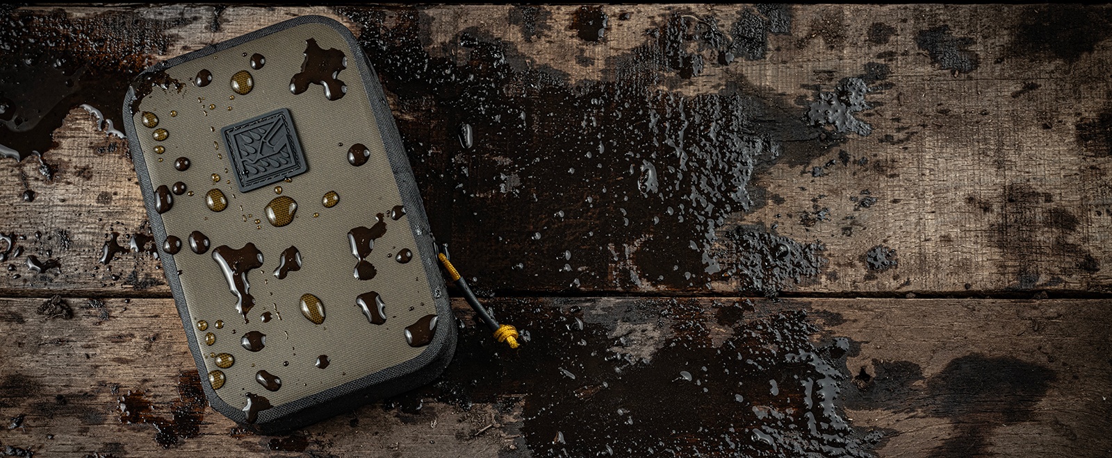 Brown storage pouch on muddy wood background