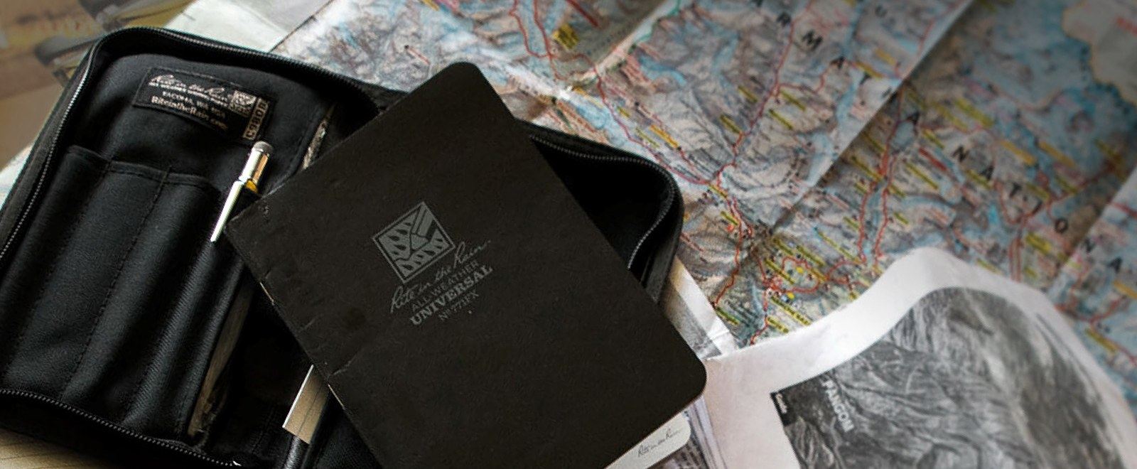 Side bound notebook and cover sitting on a map.